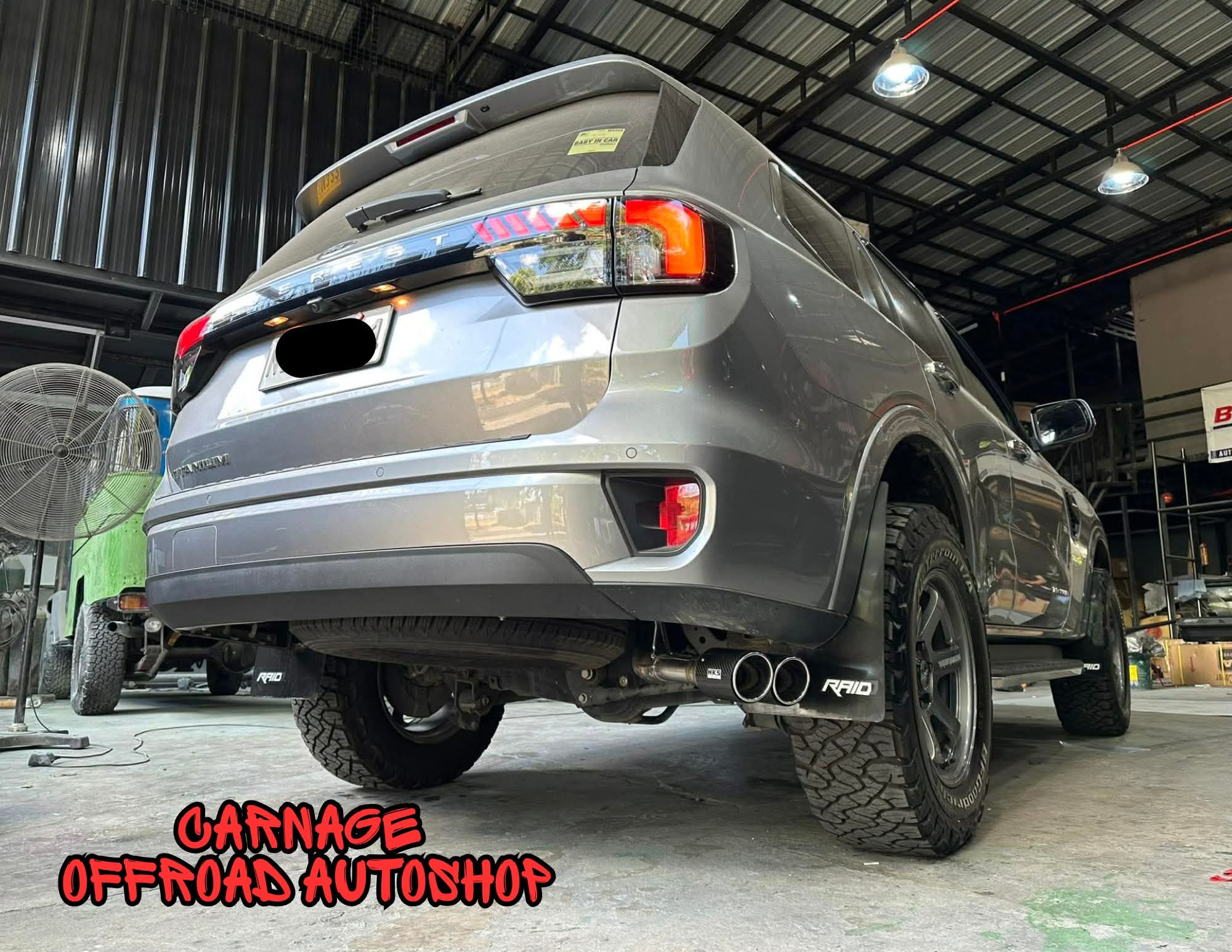 Lifted SUV with offroad mags and mud-terrain tires — finished install
